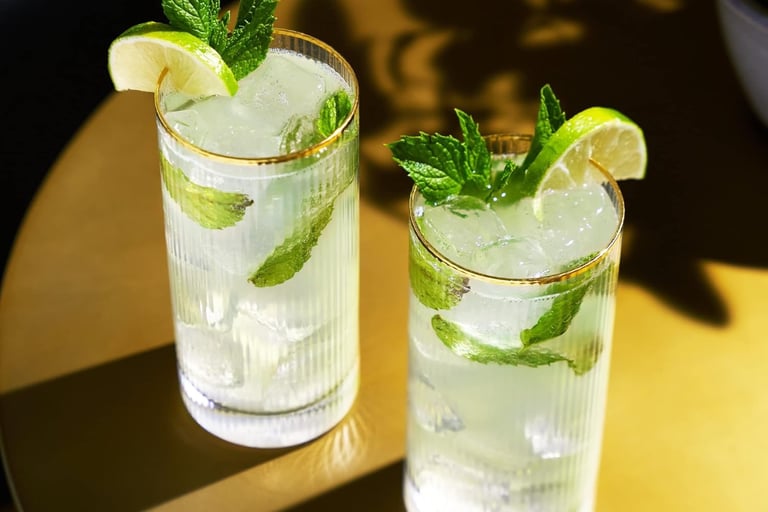 two glasses of water with lemonade and mint leaves