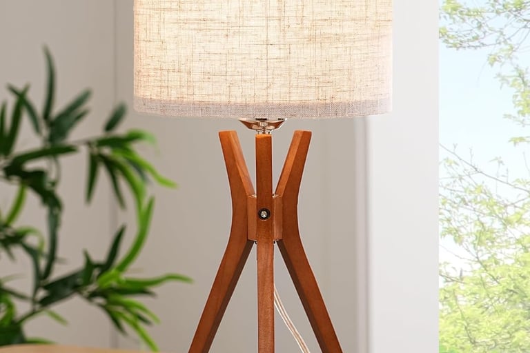 a mid-century tripod lamp that is sitting on a table