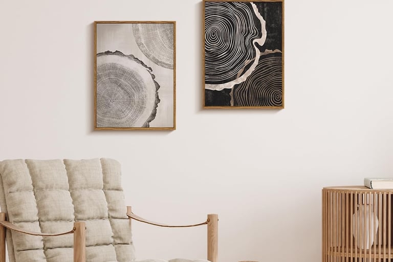 a chair with a hanging neutral wall art and a wooden cabinet