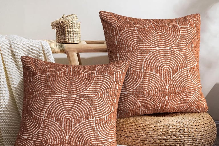 a pair of decorative pillows with a brown and white swirly pattern
