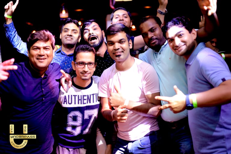 a group of men standing around a man holding a peace sign