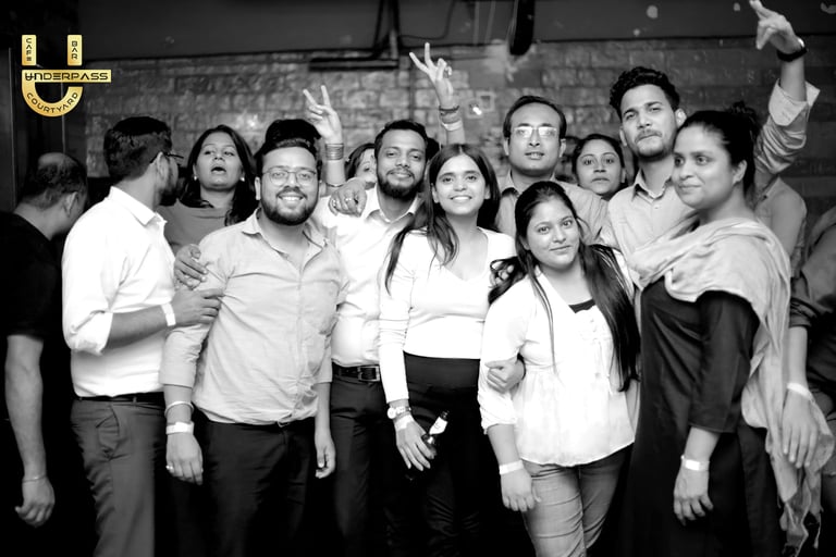 a group of people standing around a man in a white shirt