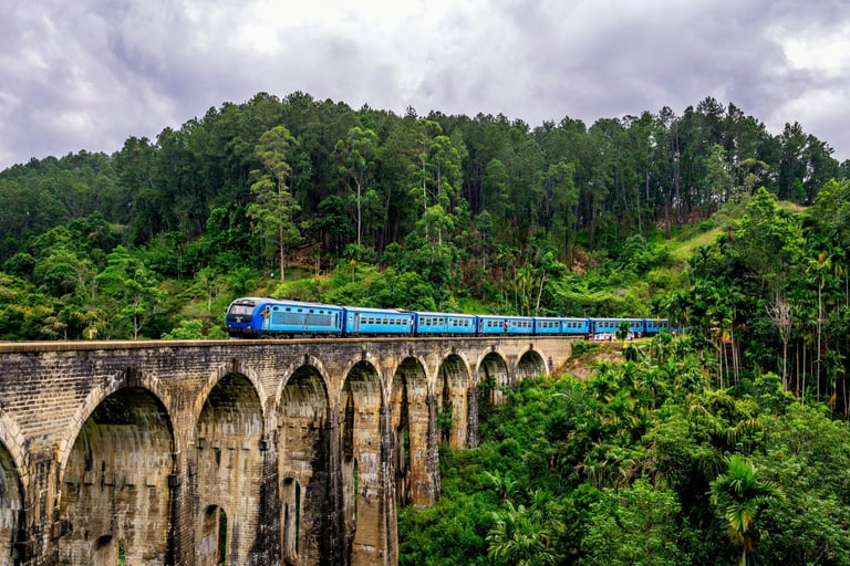 a train on a bridge over a river