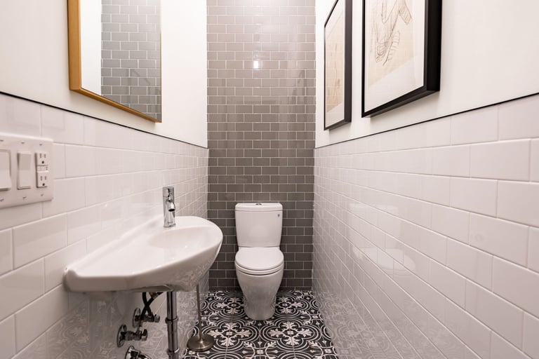 a small powder room design with a toilet and a sink