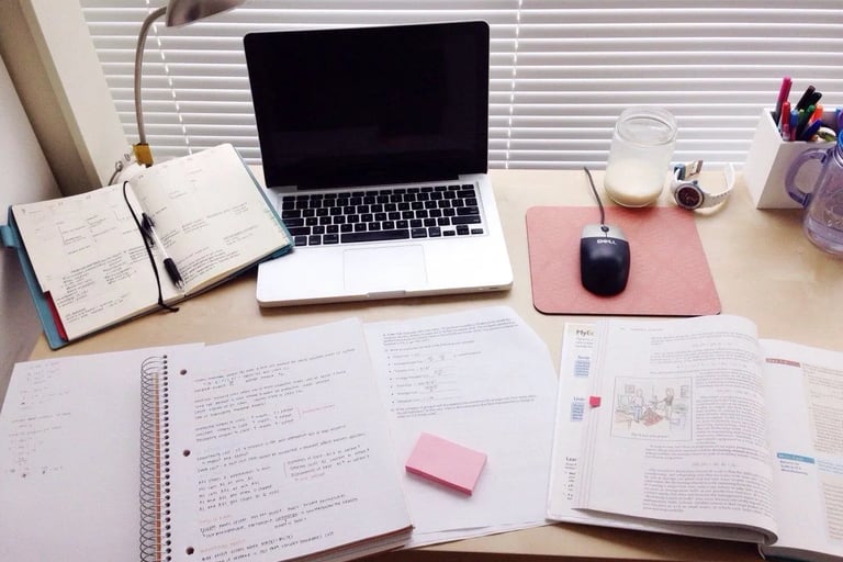 a laptop computer sitting on a desk with a laptop and a mouse