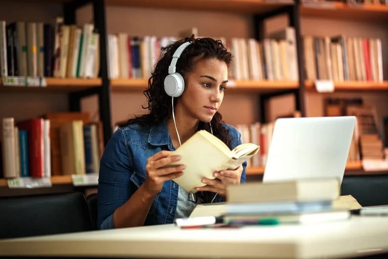 a woman in headphones and headphones is sitting at a desk