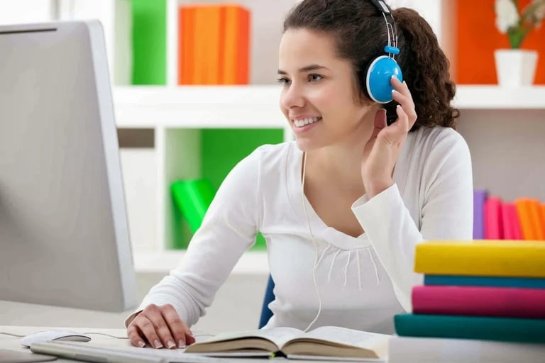 a woman in headphones and headphones is sitting at a desk