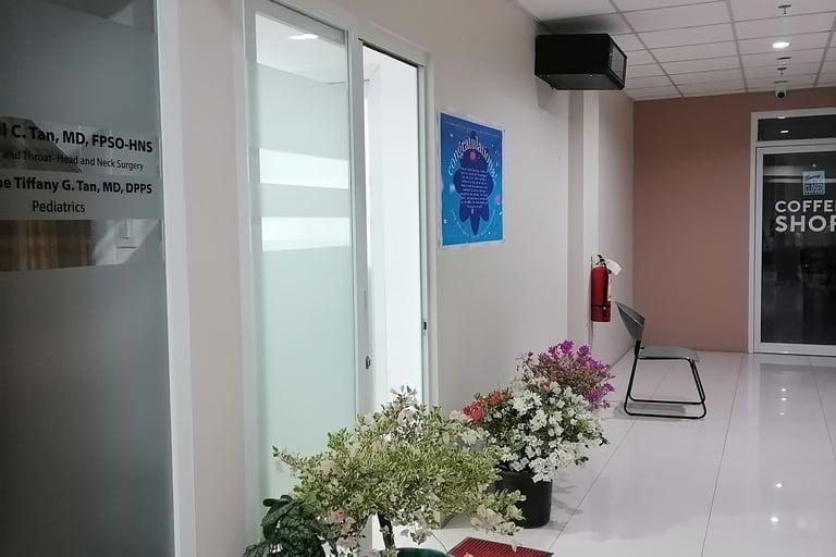 a hallway with a lot of plants and a sign