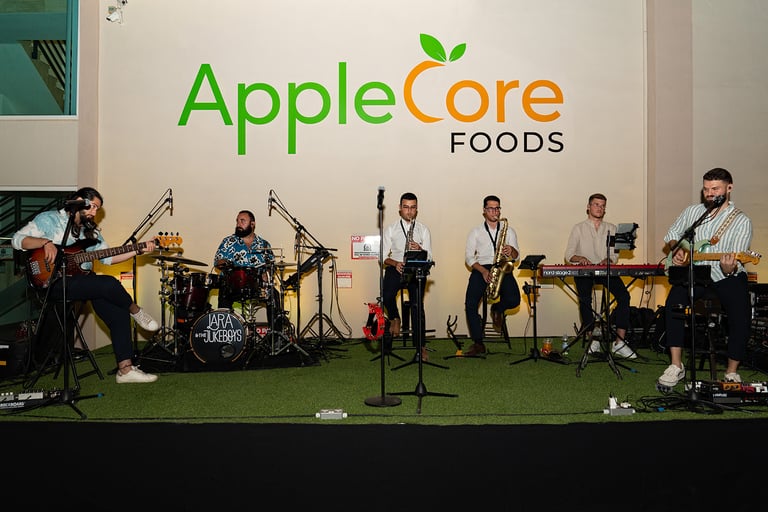 a band of musicians performing at an applecore foods event