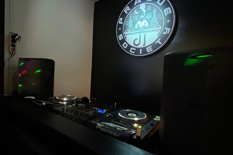 DJ Society booth with Pioneer setup and studio logo illuminated.