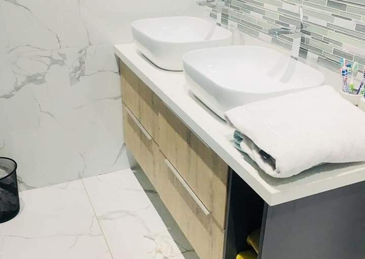 a bathroom with two sinks and a toilet