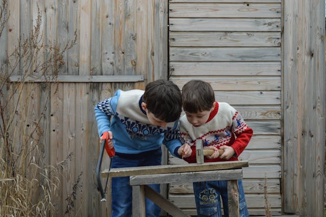 two boys playing with a hammer hammer and a hammer hammer