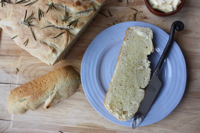 sliced rosemary focaccia bread with melted butter