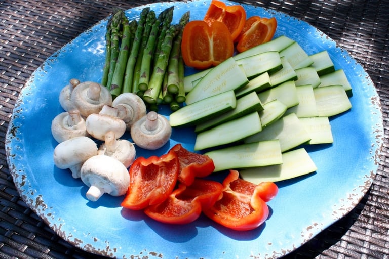raw and sliced peppers, zucchini, mushrooms and asparagus