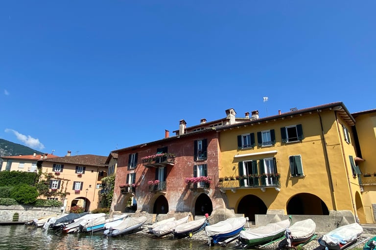 Mandello del Lario village on Lake Como with colorful boats along the shore