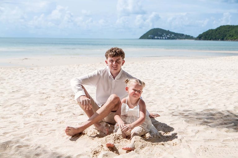 Brother and sister sitting together on Khem Beach