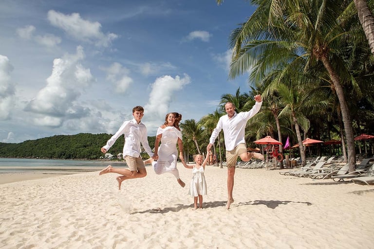 Family jumping together on Khem Beach in Phu Quoc