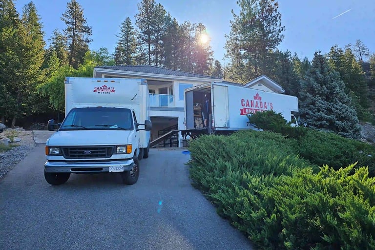 Canada’s Most Wanted Movers trucks loading at a hillside residential property in the Lower Mainland.