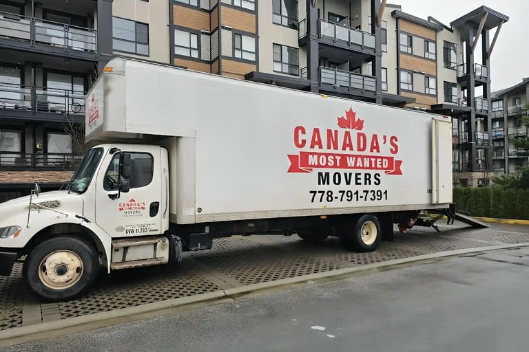 Canada’s Most Wanted Movers truck parked outside a condo complex in Langley for an apartment move.