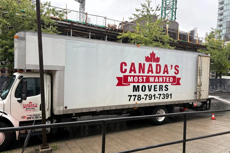 Canada’s Most Wanted Movers truck parked beside a construction project in Surrey, ready for a commercial move.