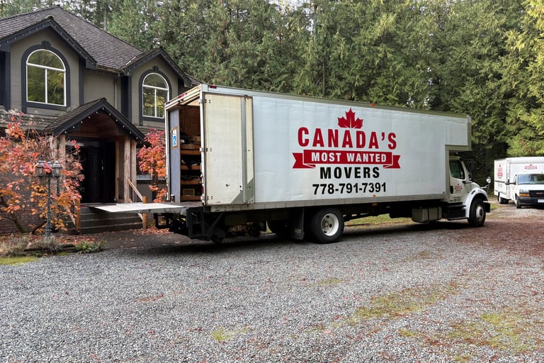 Canada’s Most Wanted Movers truck parked at a forest-side home in the Lower Mainland during a residential move.