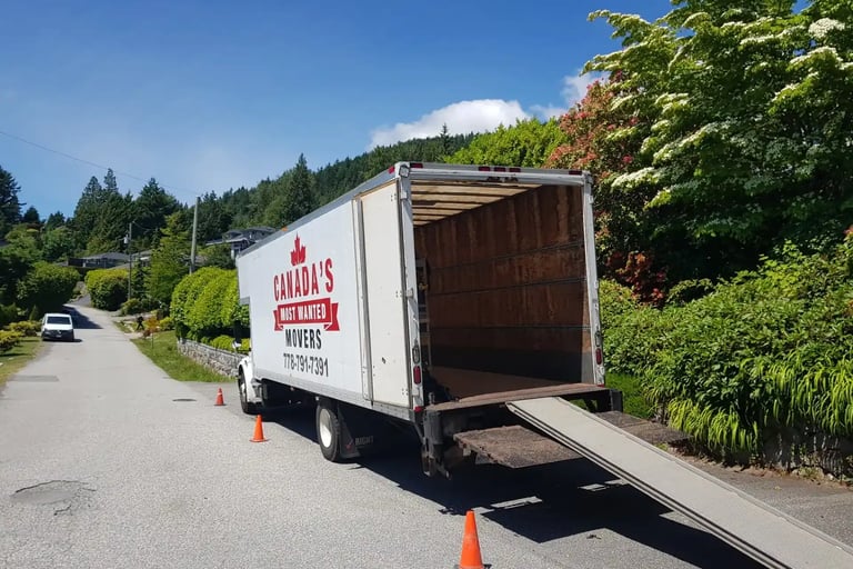 Canada’s Most Wanted Movers truck unloading at a quiet residential street on Vancouver Island.
