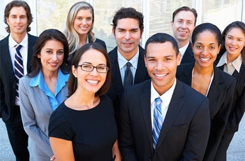 a group of business people standing in front of a building
