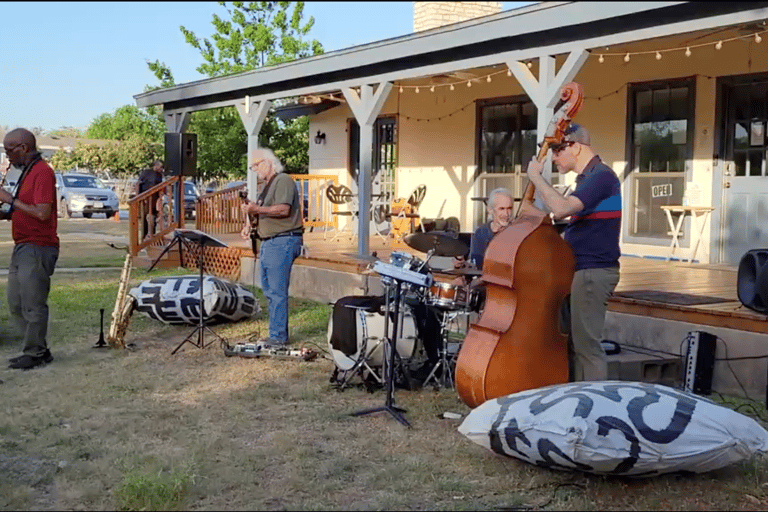 a group of musicians playing instruments outdoors