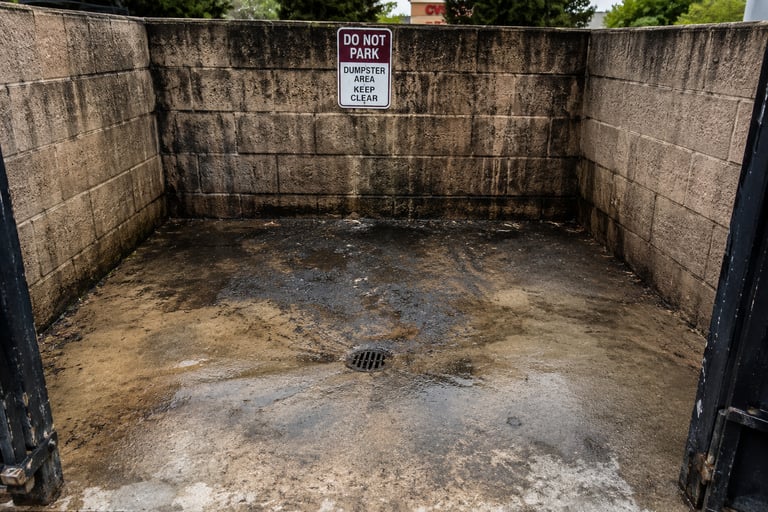 dirty/greasy dumpster enclosure area