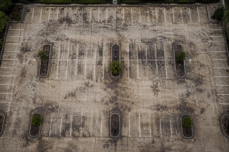 Top down view of a parking lot before getting pressure washed