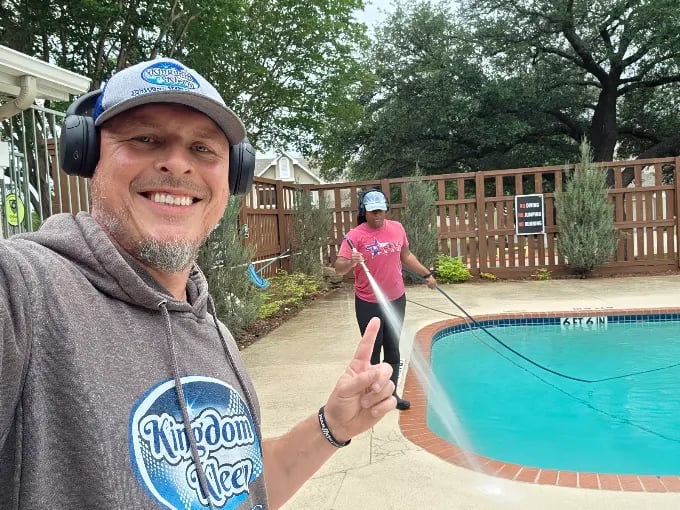 pressure washing a pool deck with the family