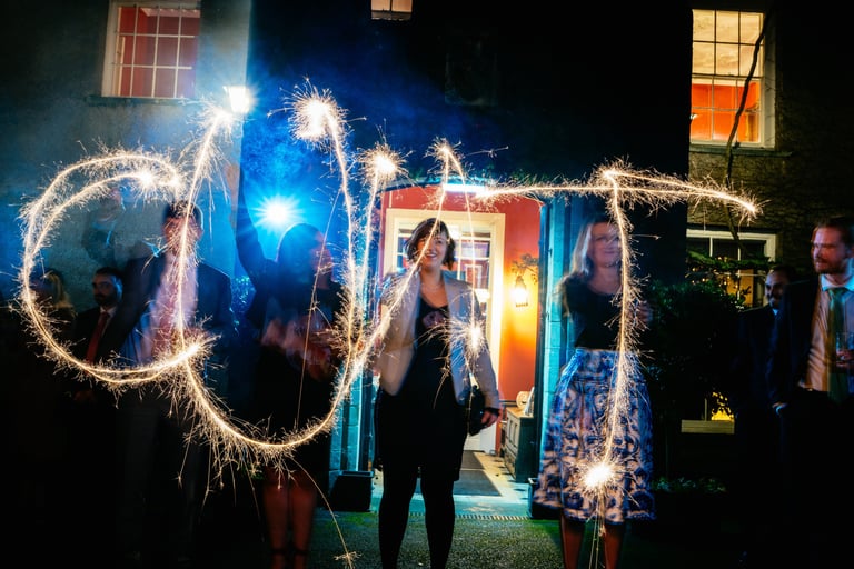 Wedding guests spelling out words with sparklers