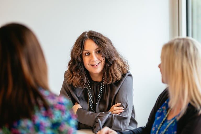 a woman in a gray jacket and a woman in a black jacket