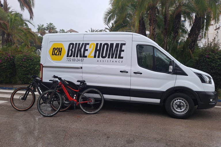 Bike2Home assistance van parked next to several mountain bikes in Marbella