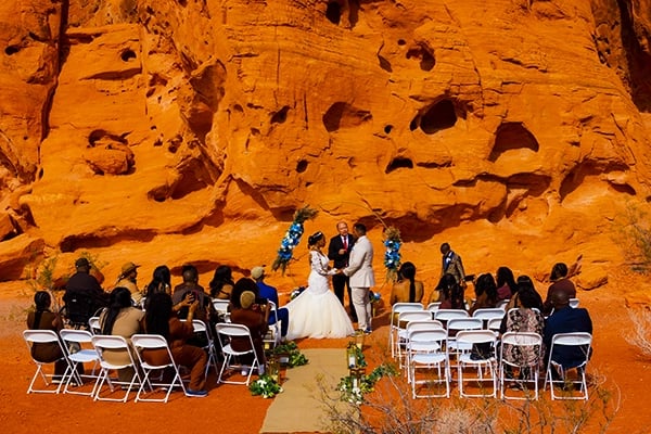 A desert wedding ceremony with a bride and groom at Valley of Fire State Park's red rock formations.
