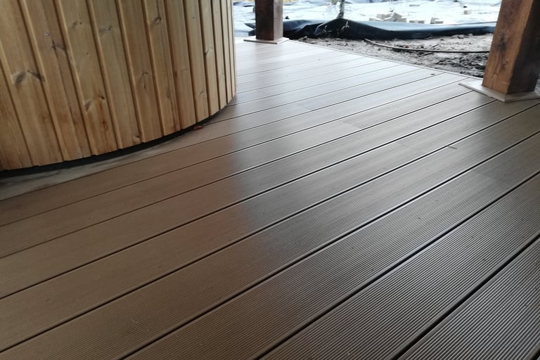 a wooden deck with a hot tub and a wooden deck