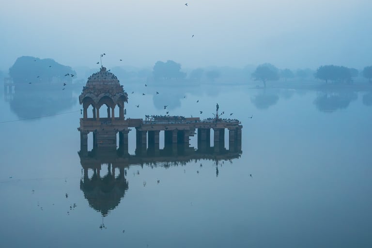 Sunrise reflections at Gadisar Lake in Jaisalmer.
