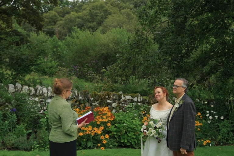 a man and woman getting married in a garden