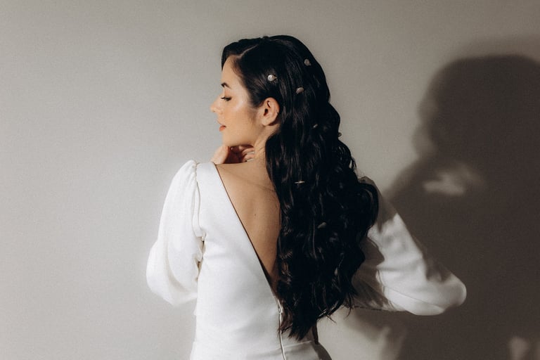 a woman in a white dress with a long sleeved dress