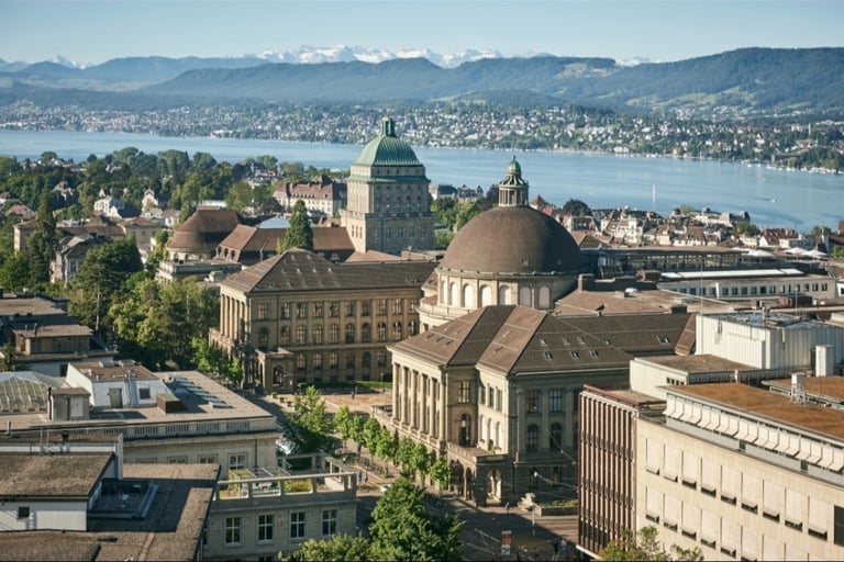 a cityscape of a large building with a dome shaped building in the background
