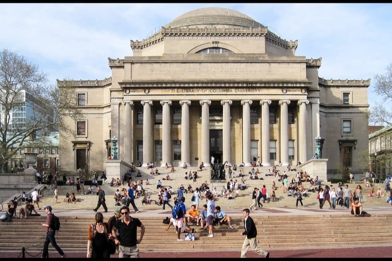 a large building with a lot of people walking up the stairs