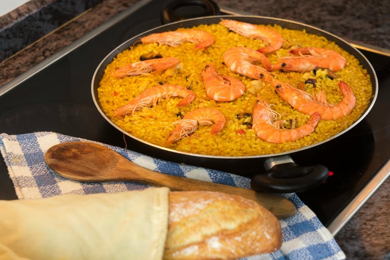 seafood paella next to a piece of bread