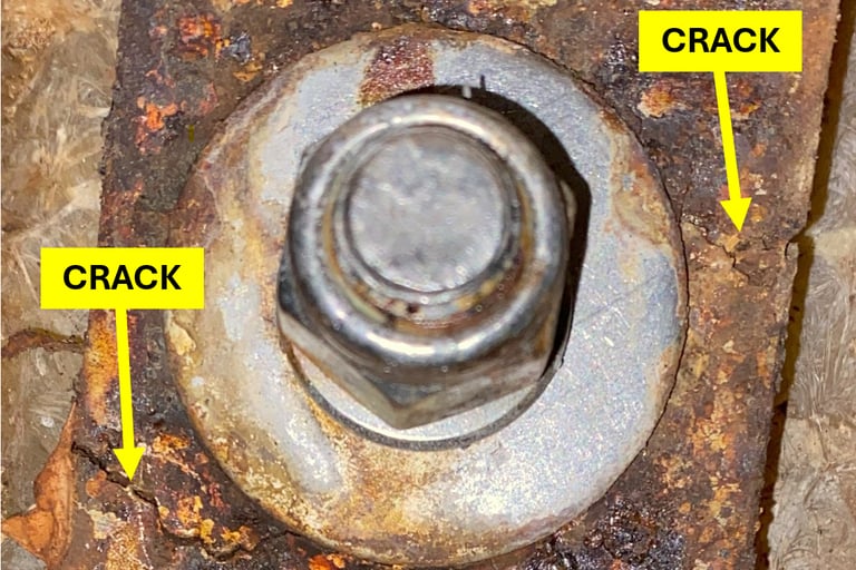 Close-up of cracked stainless steel chainplate on a cruising sailboat