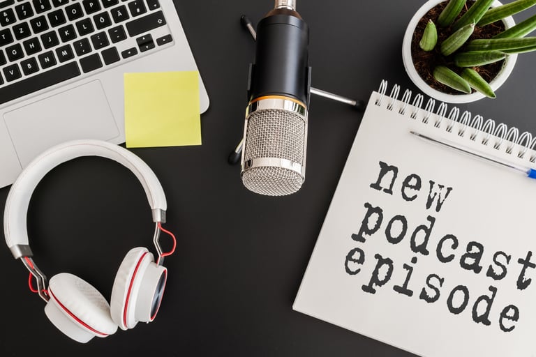a microphone and a laptop with a notepad and a notebook