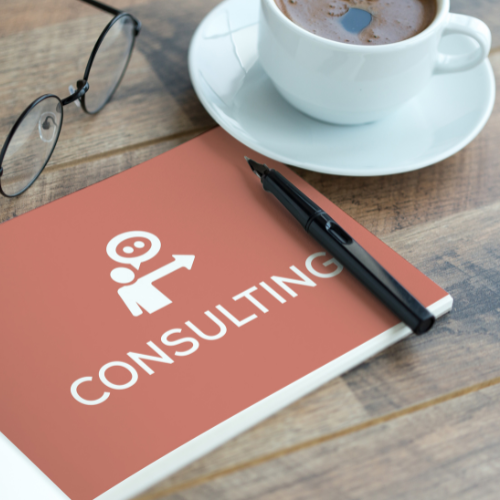 The image of the notebook titled "CONSULTING" with glasses, a pen, and a coffee cup.