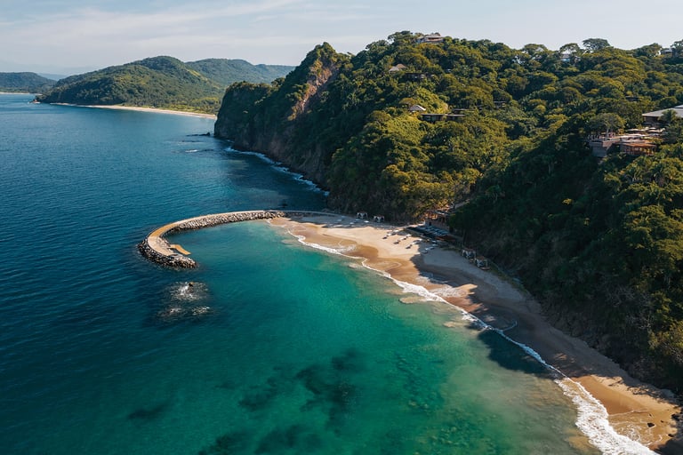 a view of a beach in Puerto Vallarta with a pier and a pier