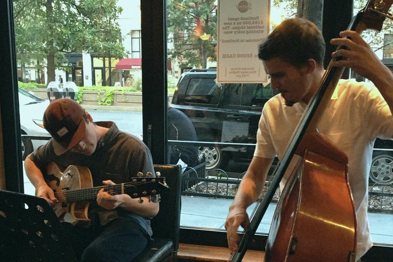 a guitarist and bassist playing in a restaurant