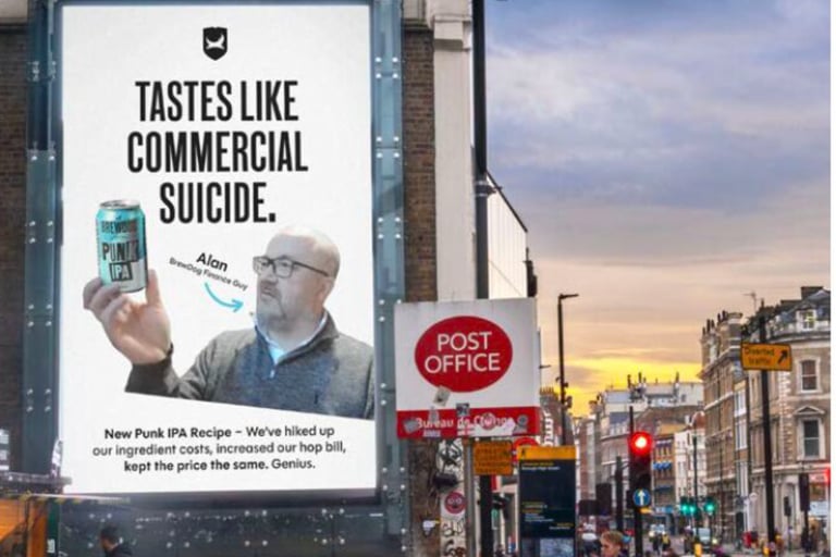 BrewDog billboard reading “Tastes like commercial suicide,” showing a man holding a can of Punk IPA on a city street.