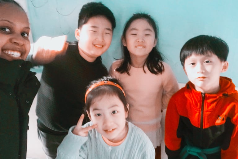 Emmy standing with 4 learners