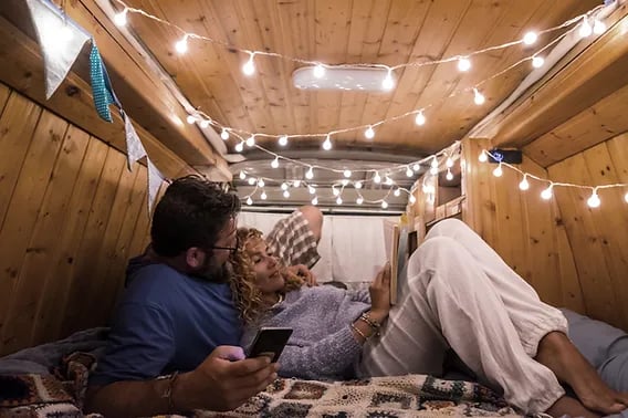 cute couple inside a small camper